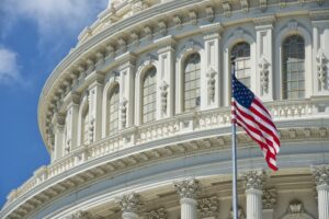 the side of capitol with American flag in front of it
